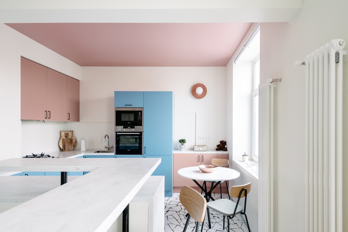 A pink kitchen with a blue accent