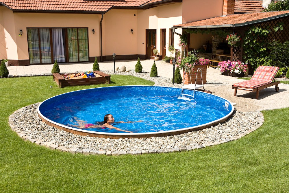 A semi inground pool in a backyard
