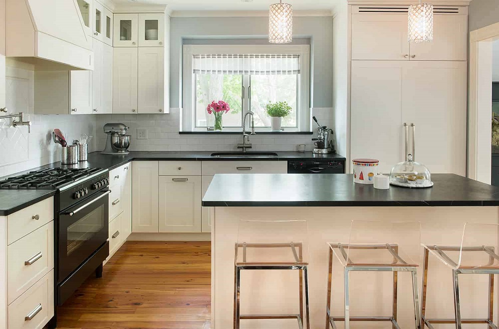 Modern beige kitchen with black countertops