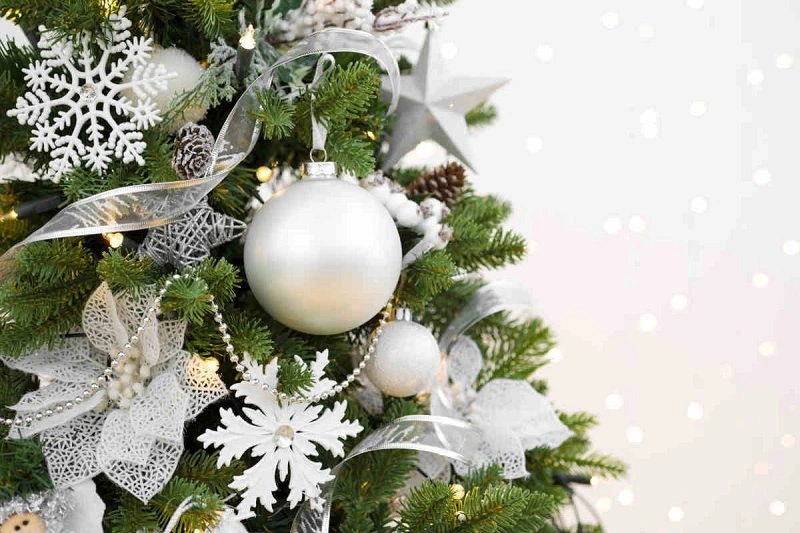 Un albero di Natale bianco e argento con decorazioni interessanti