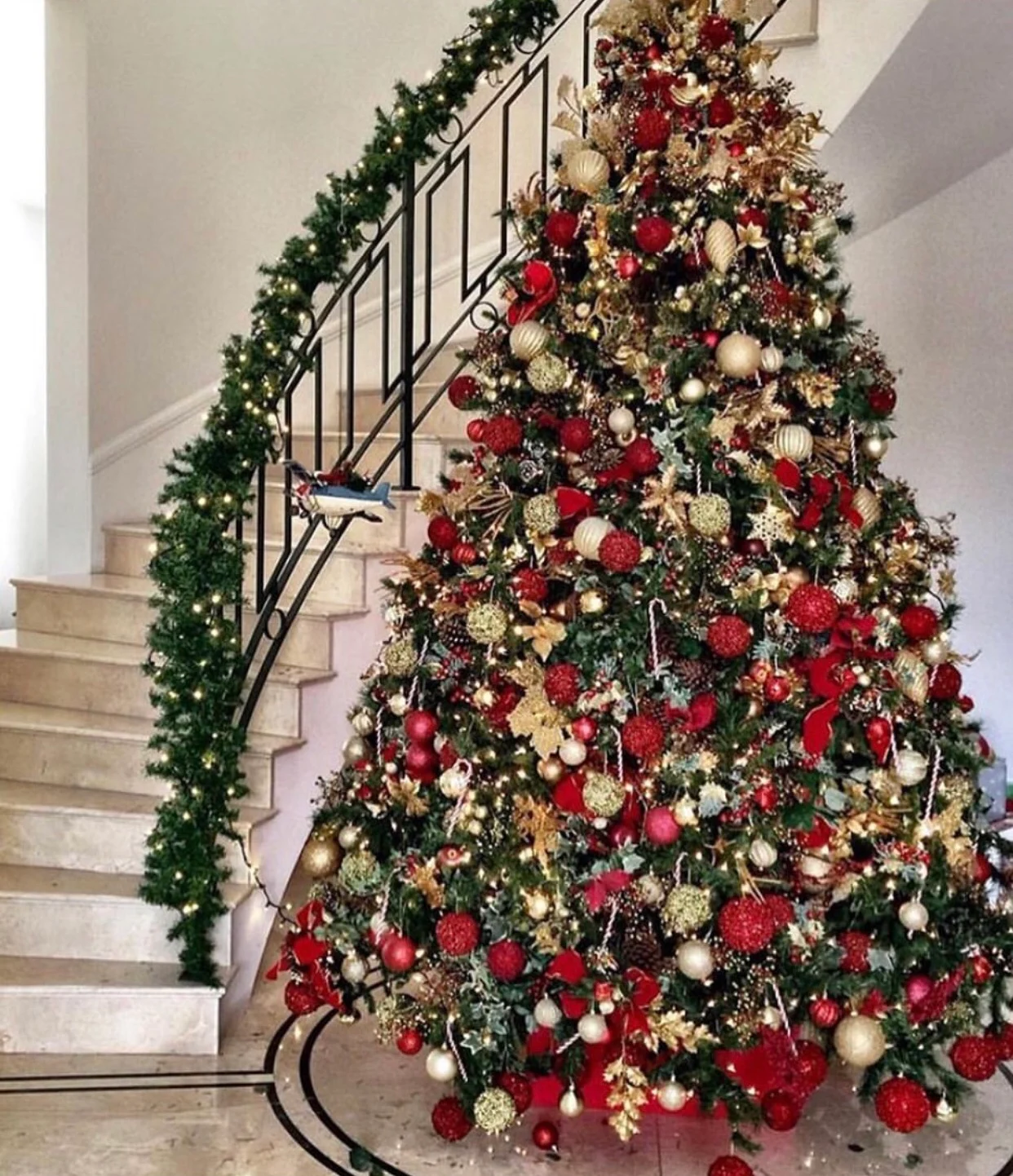A richly decorated red and gold Christmas tree