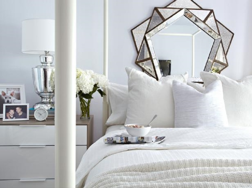 A white modern bedroom - an interesting mirror