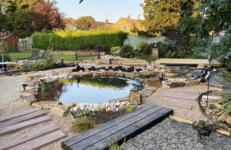 Where should a garden pond be located on the property?
