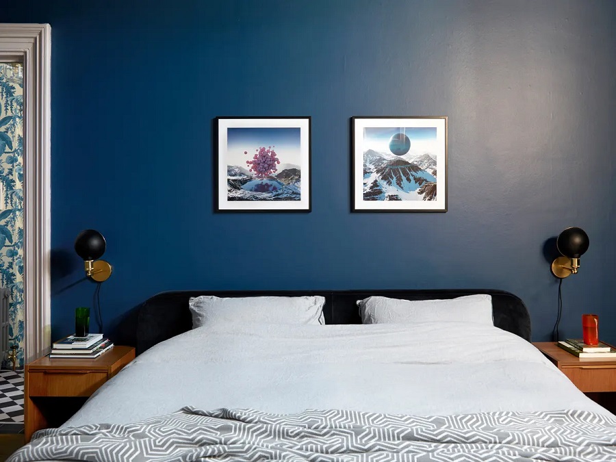 A dark blue windowless bedroom