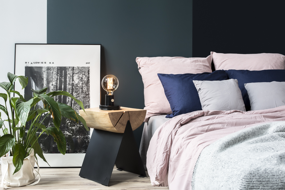 A dark blue bedroom with pink