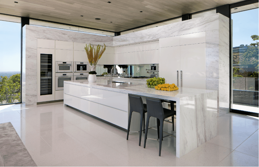 A modern kitchen with glass wall and a view