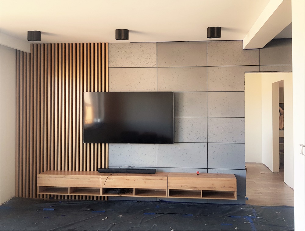 A wood slat wall and concrete in the living room