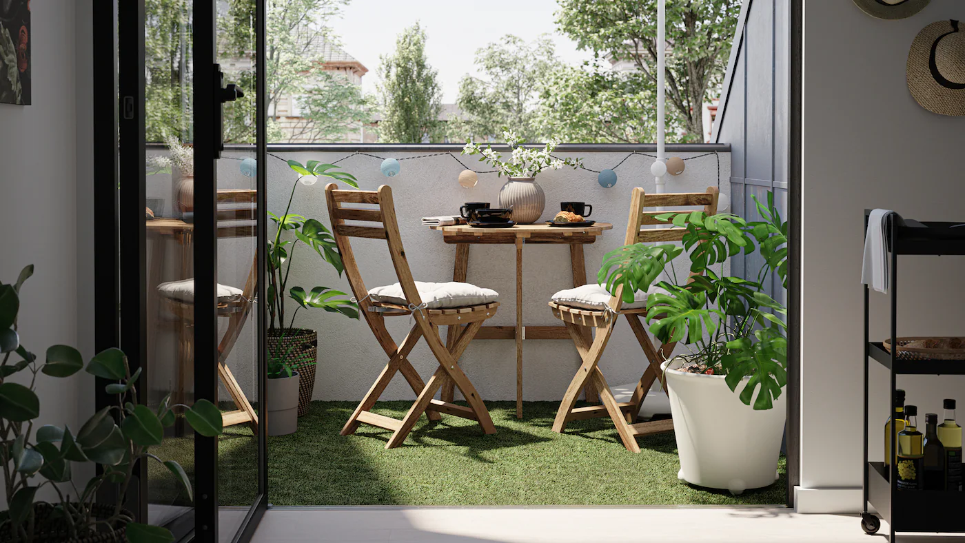 Synthetic grass on a balcony wooden furniture